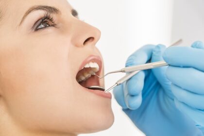 Know The Tooth Filling Cost Before You Proceed Woman at Dentist Miami