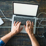 a person connecting his laptop to a cable internet