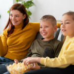 a group of friends sitting together and watching tv