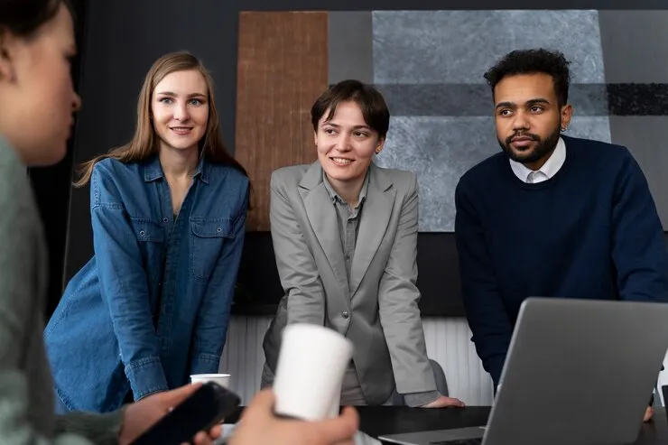 Certified workday employees discusses work together in the office